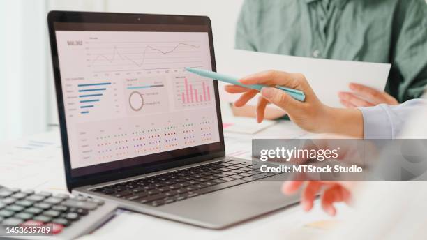 closeup group of asian business people meeting discuss project plan and financial results in office. - chart stockfoto's en -beelden