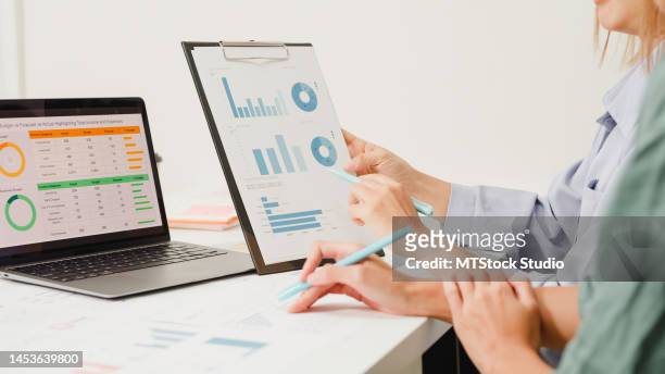 closeup group of asian business people meeting discuss project plan and financial results in office. - cost management stock pictures, royalty-free photos & images