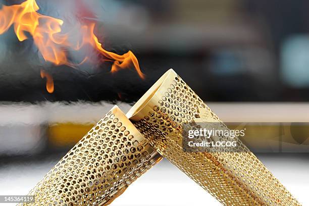 In this handout image provided by LOCOG, TThe Olympic Flame during a hand-over on the leg between Cardigan/Aberteifi and Brynhoffnant. On May 27,...