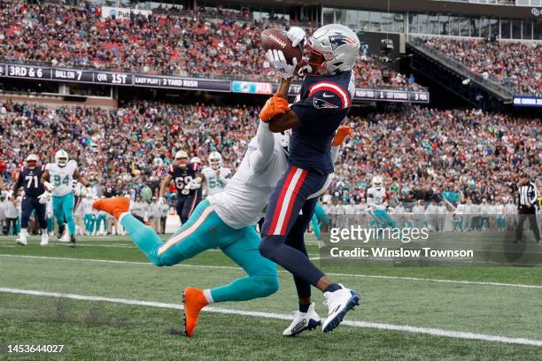 Tyquan Thornton of the New England Patriots catches a pass for a touchdown against Noah Igbinoghene of the Miami Dolphins during the first quarter at...