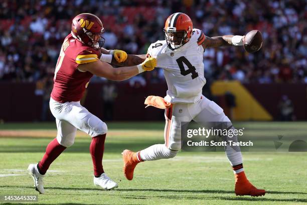 Deshaun Watson of the Cleveland Browns runs the ball against David Mayo of the Washington Commanders during the first quarter at FedExField on...