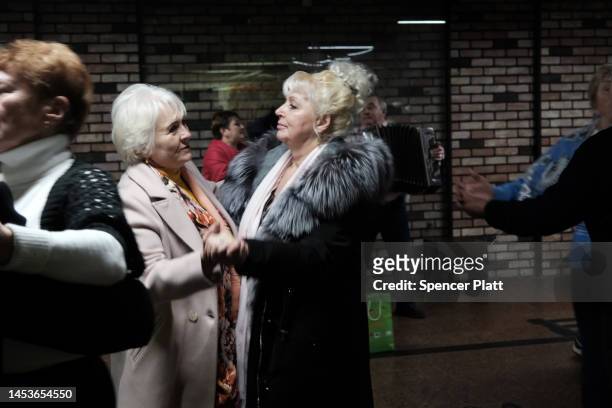 Elderly couples participate in an ongoing traditional dance gathering in an underground mall on January 01, 2023 in Kyiv, Ukraine. Kyiv, and much of...