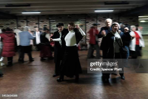 Elderly couples participate in an ongoing traditional dance gathering in an underground mall on January 01, 2023 in Kyiv, Ukraine. Kyiv, and much of...