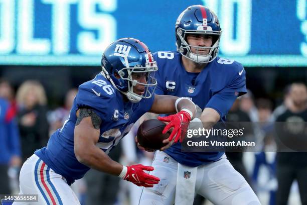 Daniel Jones of the New York Giants hands off to Saquon Barkley of the New York Giants during the third quarter against the Indianapolis Colts at...