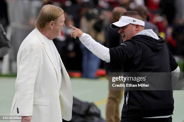 Owner and managing general partner Mark Davis of the Las Vegas Raiders talks with head coach Josh McDaniels on the Raiders' sideline before the...