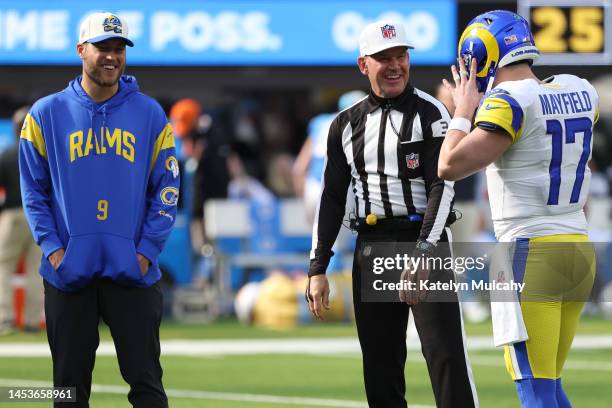 Baker Mayfield of the Los Angeles Rams speaks with referee Clete Blakeman and Matthew Stafford of the Los Angeles Rams prior to the game against the...