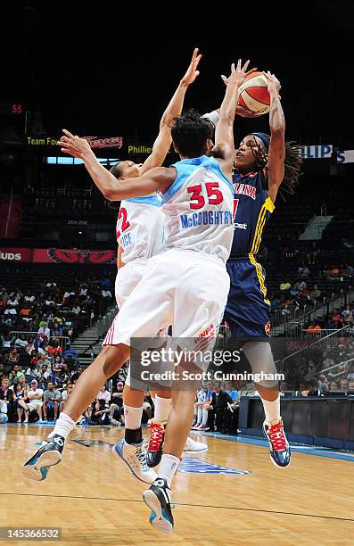 Shavonte Zellous of the Indiana Fever shoots against Angel McCoughtry and Armintie Price of the Atlanta Dream at Philips Arena on May 27, 2012 in...