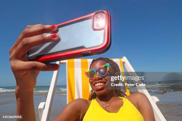 dark skinned woman on beach - beach holiday uk stock pictures, royalty-free photos & images