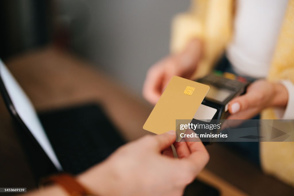 Close Up Photo Of Woman Hands Paying With Credit Card In A Home Decor Store