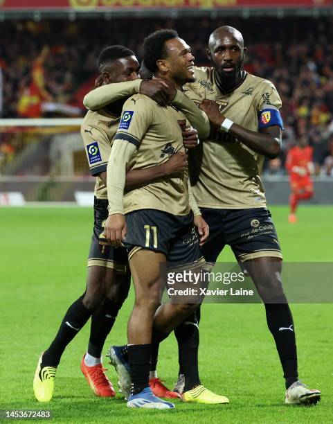 Lois Openda of RC Lens celebrate his goal with captain Seko Fofoana and teammates during the Ligue 1 match between RC Lens and Paris Saint-Germain at...