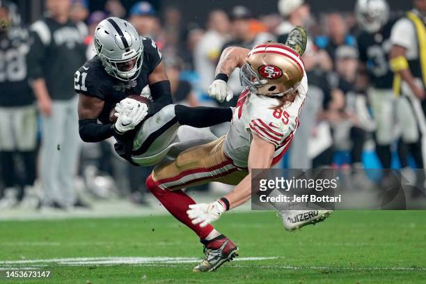 Amik Robertson of the Las Vegas Raiders intercepts a pass intended for George Kittle of the San Francisco 49ers during the third quarter at Allegiant...
