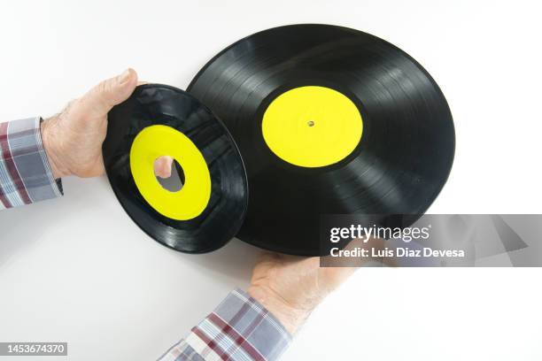 hands holding vinyl records - 45 rpm stock pictures, royalty-free photos & images