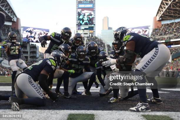 Mike Jackson of the Seattle Seahawks celebrates an interception with teammates during the fourth quarter in the game against the New York Jets at...