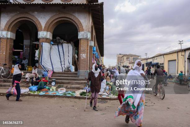 Woman crosses the street between market venues at the Shuq in the city center on December 31, 2022 in Asmara, Eritrea. The Shuq is a large open air...