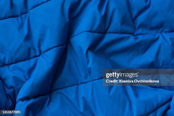 down jacket fabric background, blue puffer jacket texture - blue jacket stock pictures, royalty-free photos & images