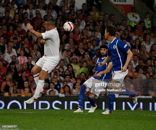 Robbie Williams and Sergio Pizzorno participate in the Soccer Aid football match in aid of Unicef at Old Trafford at Old Trafford on May 27, 2012 in...