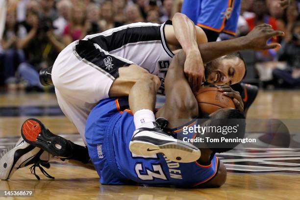 Manu Ginobili of the San Antonio Spurs battles for the ball on the floor with James Harden of the Oklahoma City Thunder in the first quarter in Game...
