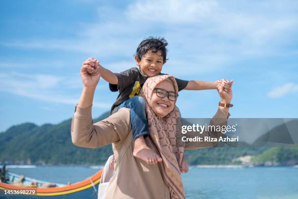 mother and daughter playing outdoors - kids fun indonesia stock pictures, royalty-free photos & images