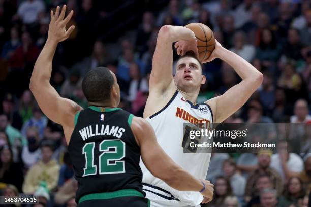 Nikola Jokic of the Denver Nuggets puts up a shot against Grant Williams of the Boston Celtics during the fourth quarter at Ball Arena on January 01,...