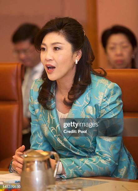 Prime Minister of Thailand, Ms Yingluck Shanawatra talks with Australian Prime Minister Julia Gillard during a cabinet meeting at Parliament House on...