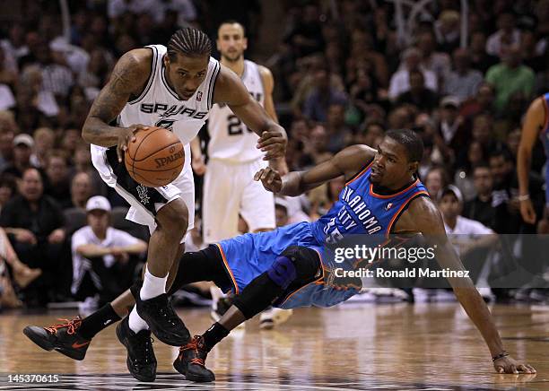 Kawhi Leonard of the San Antonio Spurs dribbles the ball alongside Kevin Durant of the Oklahoma City Thunder in the second half in Game One of the...