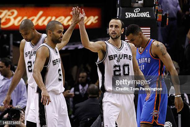 Tony Parker and Manu Ginobili of the San Antonio Spurs celebrate a play in front of Thabo Sefolosha of the Oklahoma City Thunder in the fourth...