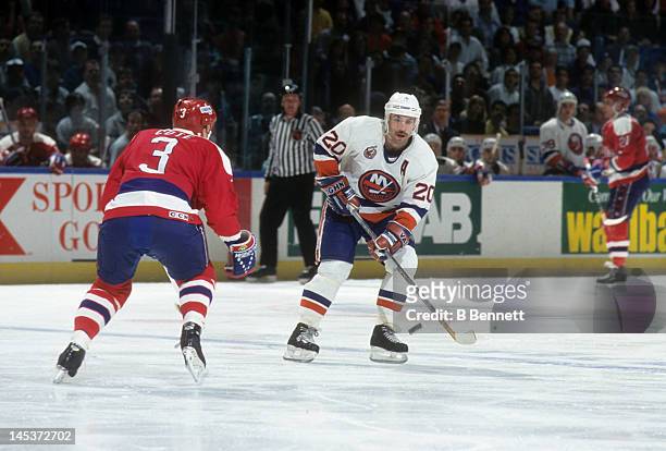 Ray Ferraro of the New York Islanders skates on the ice as Sylvain Cote of the Washington Capitals defends circa 1993 at the Nassau Coliseum in...