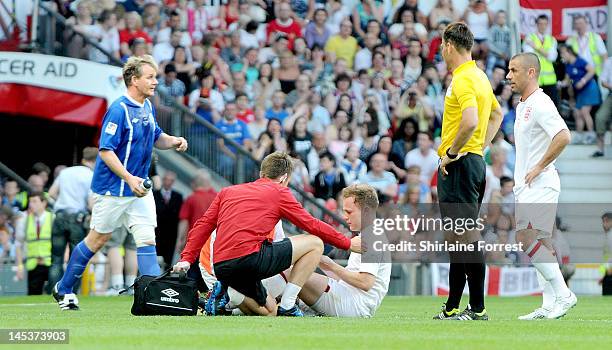 Olly Murs is injured while playing in charity football event Soccer Aid 2012 to raise funds for UNICEF on May 27, 2012 in Manchester, United Kingdom.
