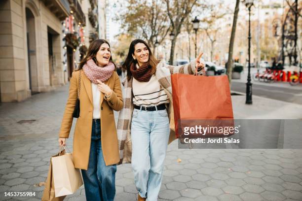 same-sex couple shopping around town - barcelona shopping stock pictures, royalty-free photos & images