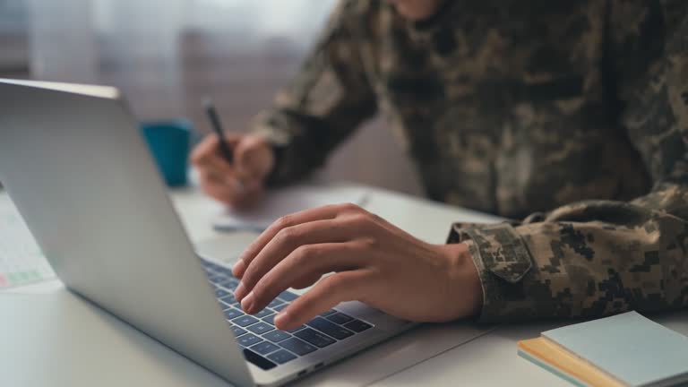 https://media.gettyimages.com/id/1453759915/video/closeup-of-soldier-taking-notes-while-typing-on-laptop-getting-education.jpg?b=1&s=640x640&k=20&c=Wmsc6aAxF4pBMKfIk4Z7wWViAisTsofl0eVgK93nZVE=