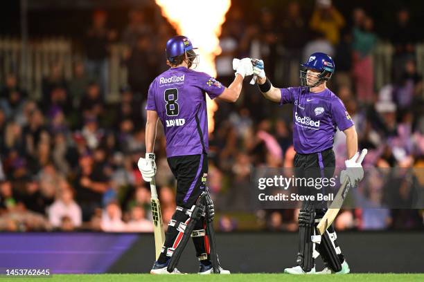 Arcy Short and Tim David of the Hurricanes celebrate the win during the Men's Big Bash League match between the Hobart Hurricanes and the Adelaide...