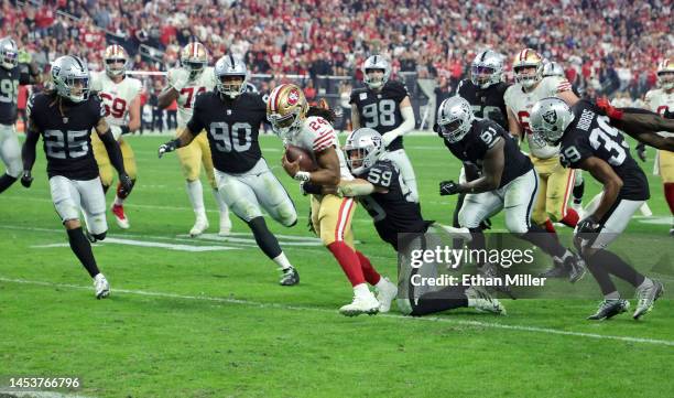 Running back Jordan Mason of the San Francisco 49ers scores on a 14-yard touchdown, his first NFL touchdown, against safety Tre'von Moehrig,...