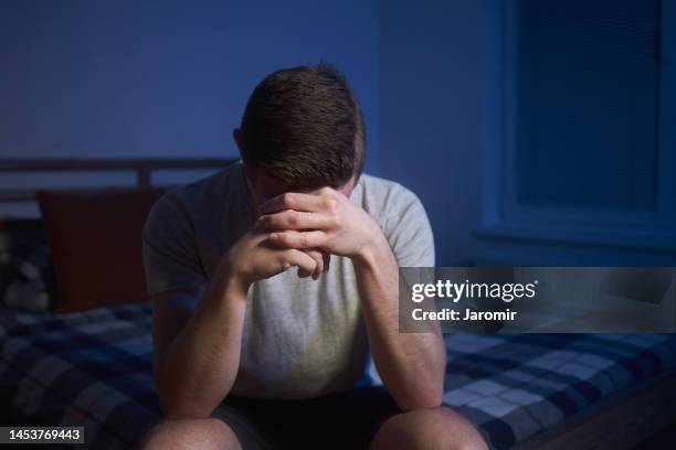 lonely depressive man with head in hands - man cry touching stock pictures, royalty-free photos & images