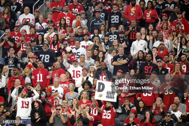 Fans react as the Las Vegas Raiders run a third-down play against the San Francisco 49ers in the third quarter of their game at Allegiant Stadium on...