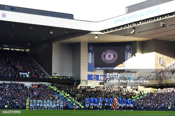 Players and fans of both teams stand at the Commemorative Service for the Ibrox Disaster prior to the Cinch Scottish Premiership match between...