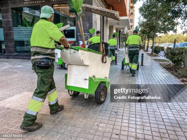 group of street sweepers in the street - cleaner man uniform stock pictures, royalty-free photos & images