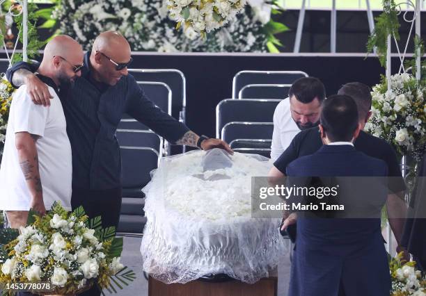 Edinho, son of Pelé, touches Pele's head during his funeral in Urbano Caldeira Stadium on January 02, 2023 in Santos, Brazil. Brazilian football icon...