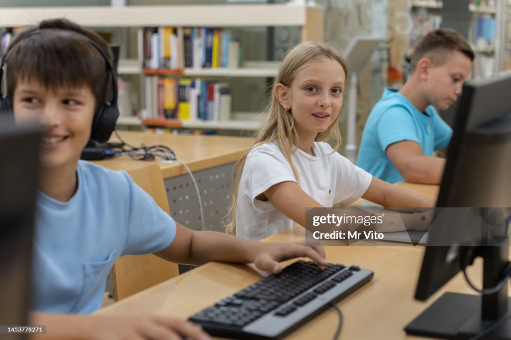 Elementary School Students On The Computers In The Library High-Res ...