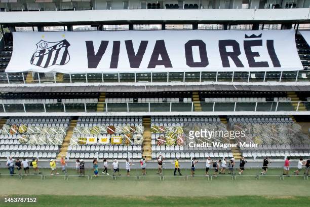 Flag remembering Pelé is displayed on the stands as mourners queue inside Vila Belmiro stadium to pay their respects to late football legend Pelé...