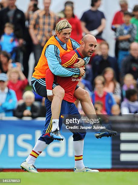 Fernando Torres of Spain takes a ride on goalkeeper's Pepe Reina his back during a training session on May 28, 2012 in Schruns, Austria.