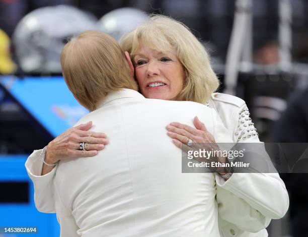 Owner and managing general partner Mark Davis of the Las Vegas Raiders hugs Gerry Plunkett, wife of former Raiders quarterback Jim Plunkett, before...