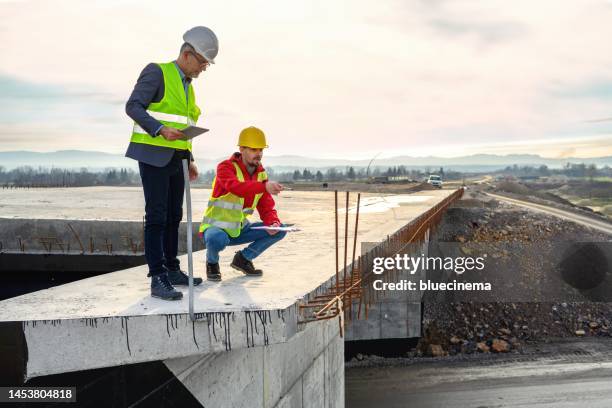 engineer and investor on a road construction site - bridge built structure stock pictures, royalty-free photos & images