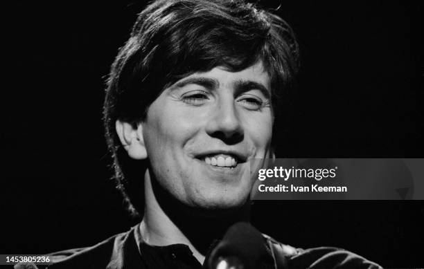 English musician Graham Nash, rhythm guitarist with the Hollies, during a performance of the song 'Bus Stop' on the set of the Associated Rediffusion...