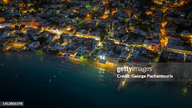 aerial photo of the beachfront houses in tolo, greece at dusk - otlo stock pictures, royalty-free photos & images