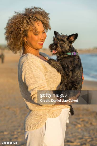 photo of woman hugging her little schnauzer dog - black hairy women bildbanksfoton och bilder