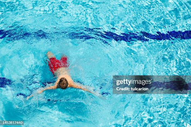 teenage boy enjoying swimming pool - public pool stock pictures, royalty-free photos & images
