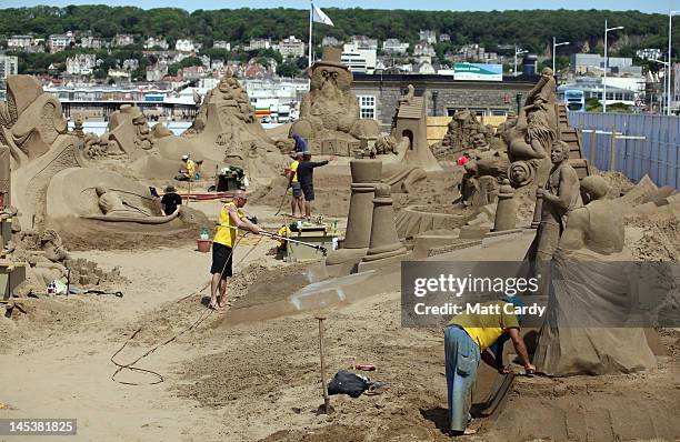 Sand sculpture artists complete sand sculptures at the annual Weston-super-Mare Sand Sculpture festival on May 28, 2012 in Weston-Super-Mare,...