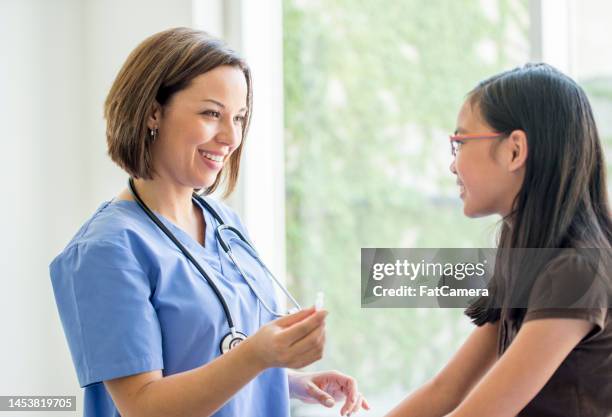 girl receiving a vaccination - s'entraîner stock pictures, royalty-free photos & images