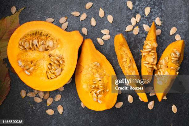 orange pumpkin cut into pieces with seeds - gourd bildbanksfoton och bilder