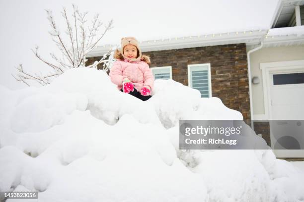 little girl playing in winter snow - utah house stock pictures, royalty-free photos & images